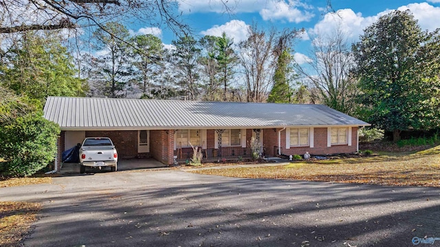 single story home with covered porch and a carport