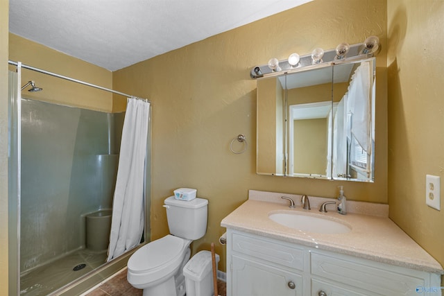 bathroom featuring curtained shower, tile patterned flooring, vanity, and toilet