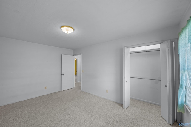 unfurnished bedroom featuring light carpet