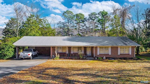 ranch-style house with a porch, a carport, and a front lawn