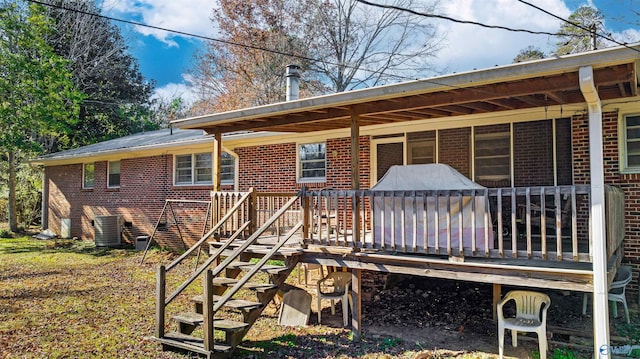 rear view of property with central air condition unit and a deck