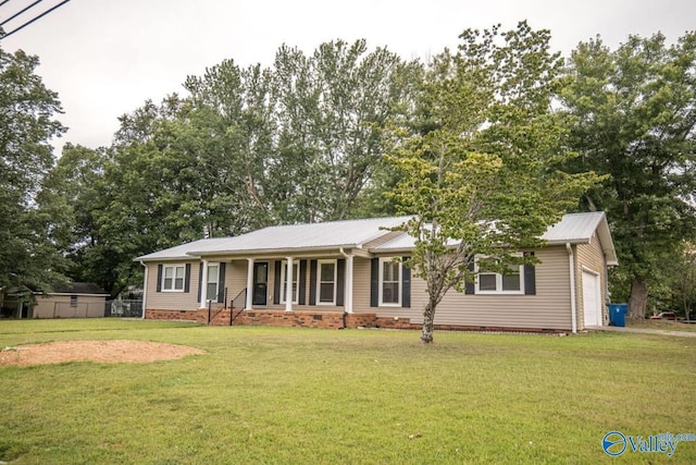 ranch-style home featuring a garage, a front yard, and covered porch