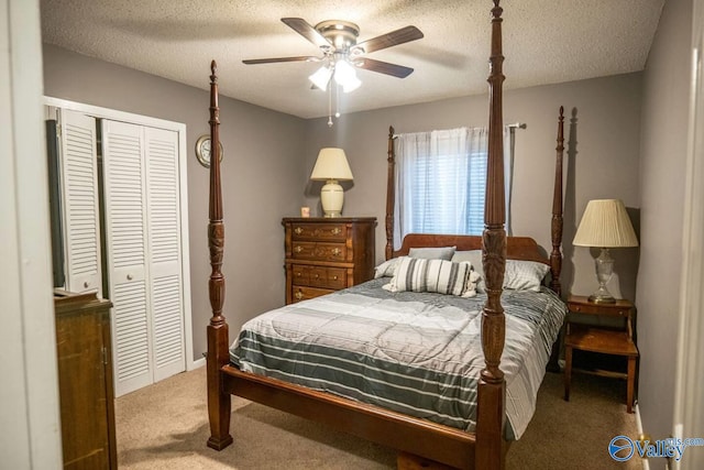 carpeted bedroom with ceiling fan, a textured ceiling, and a closet