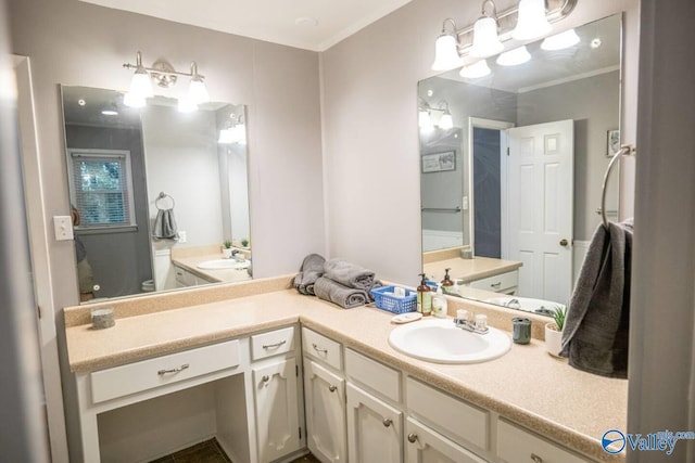 bathroom featuring vanity, toilet, and crown molding