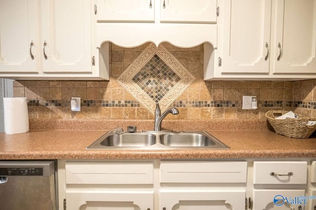 kitchen with white cabinets, decorative backsplash, stainless steel dishwasher, and sink