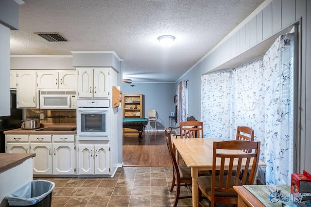 kitchen with white cabinetry, white appliances, crown molding, dark wood-type flooring, and billiards