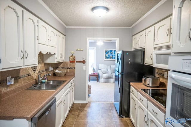 kitchen with black appliances, sink, crown molding, backsplash, and white cabinetry