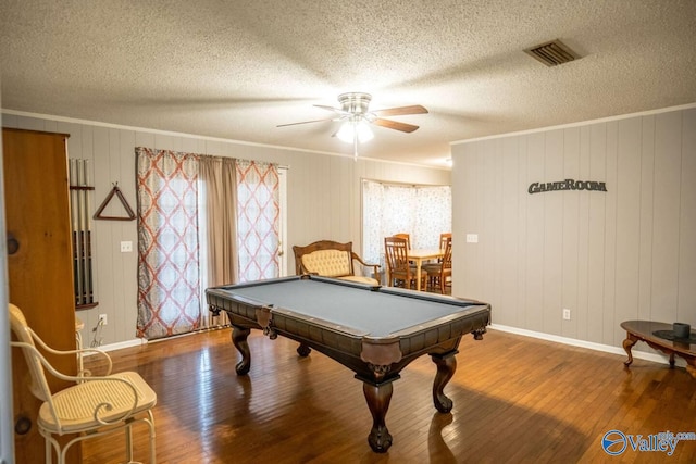 recreation room featuring hardwood / wood-style flooring, ceiling fan, a textured ceiling, and ornamental molding