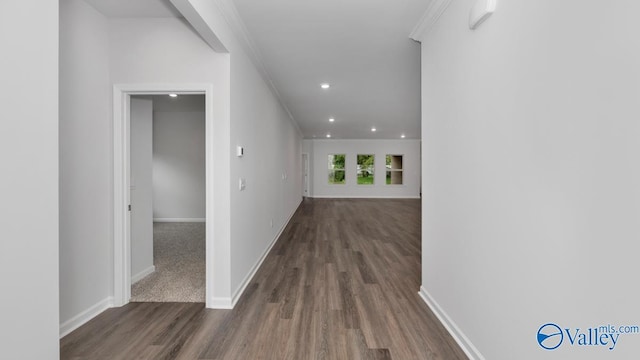 hall featuring crown molding and dark wood-type flooring