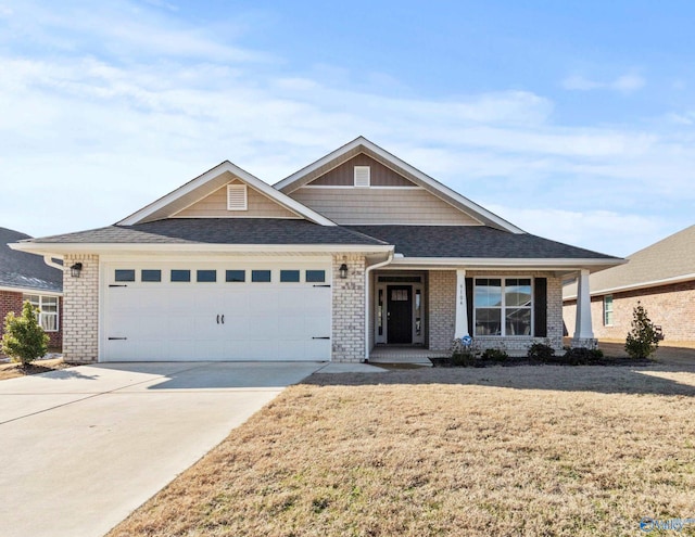 view of front facade with a garage, a front lawn, and a porch