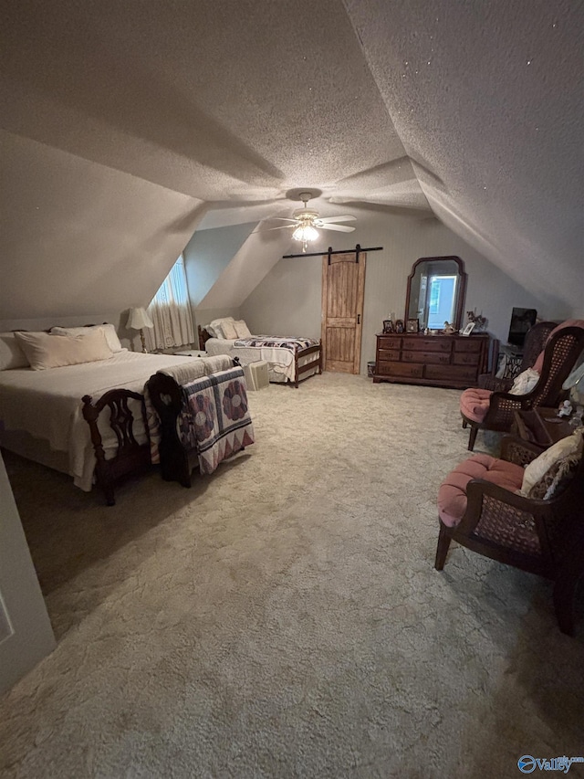 bedroom with a textured ceiling, carpet floors, lofted ceiling, and ceiling fan