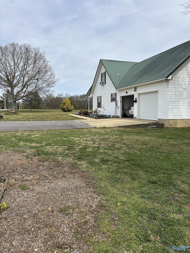 view of yard featuring driveway and an attached garage