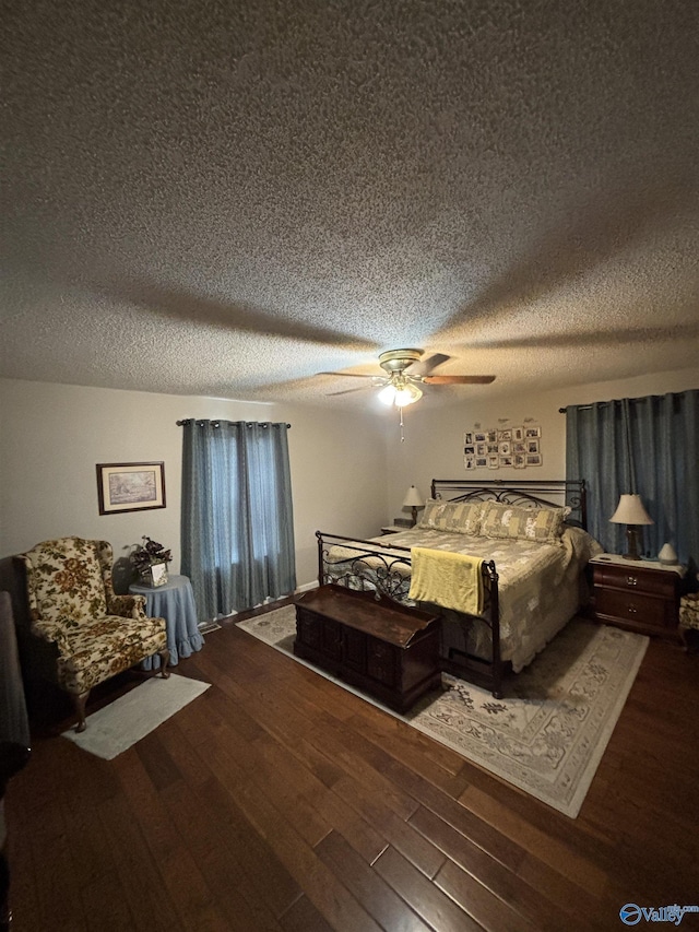 bedroom with a ceiling fan, a textured ceiling, and wood finished floors