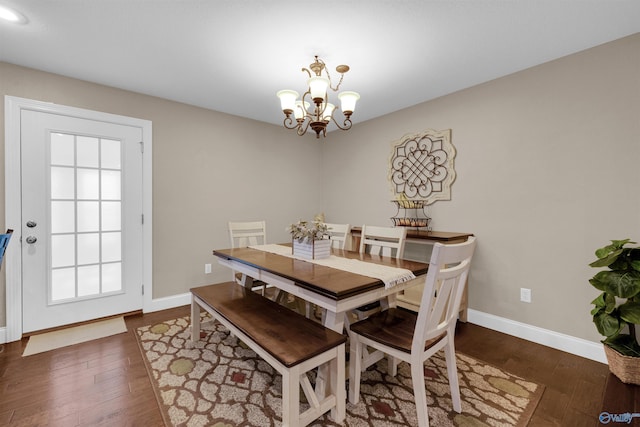 dining area featuring a notable chandelier and dark hardwood / wood-style floors