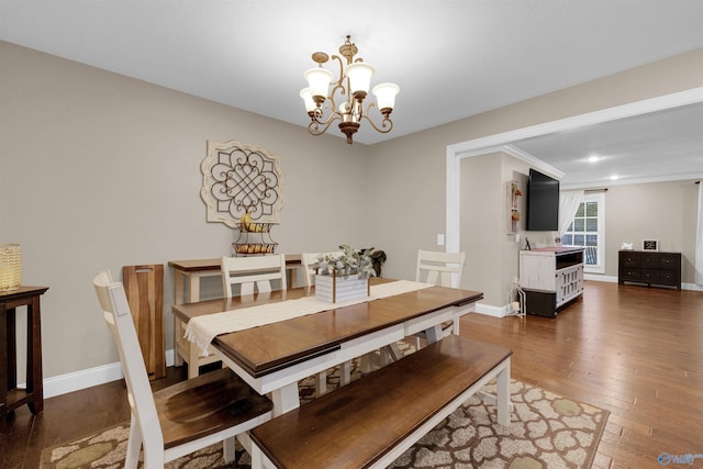 dining room with a notable chandelier and dark wood-type flooring