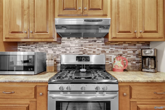 kitchen featuring light stone countertops, stainless steel appliances, extractor fan, and tasteful backsplash