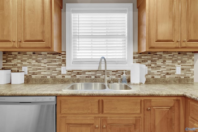 kitchen featuring sink, dishwasher, and backsplash