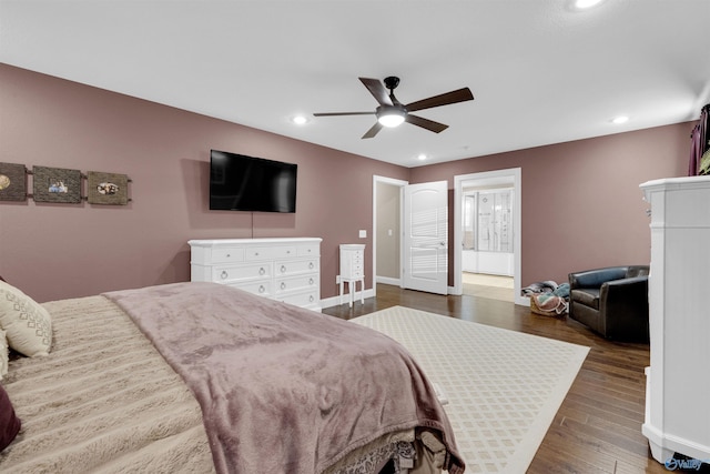 bedroom featuring dark wood-type flooring, ceiling fan, and ensuite bathroom