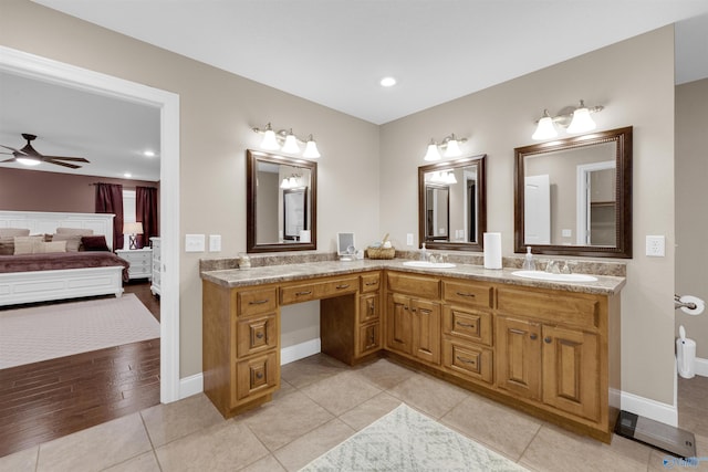 bathroom with tile patterned flooring, ceiling fan, and vanity