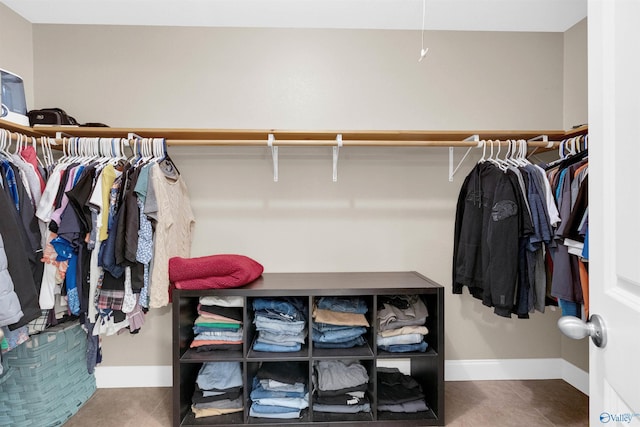 spacious closet featuring dark tile patterned flooring