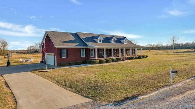 cape cod house featuring covered porch, a front lawn, and a garage