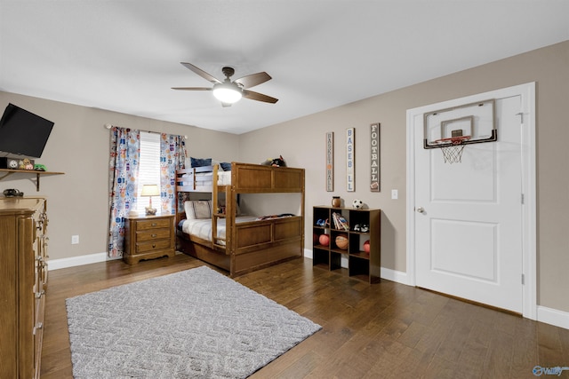 bedroom with dark hardwood / wood-style flooring and ceiling fan