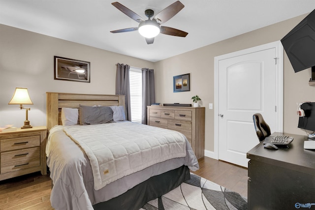 bedroom with ceiling fan and hardwood / wood-style flooring