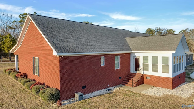 view of side of home with a yard