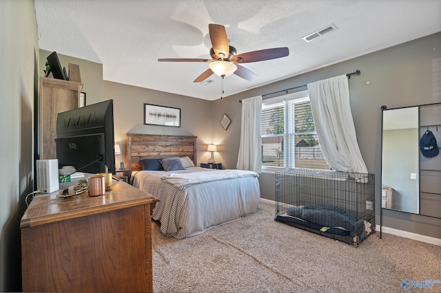 carpeted bedroom with a textured ceiling and ceiling fan