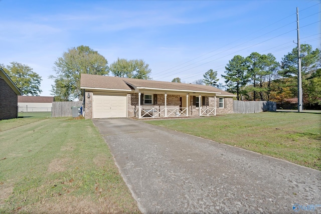 single story home featuring a garage, covered porch, and a front lawn