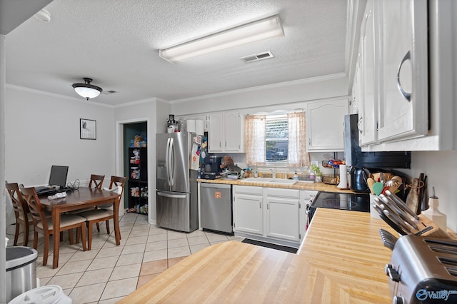 kitchen featuring sink, white cabinetry, ornamental molding, and appliances with stainless steel finishes