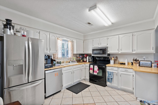 kitchen featuring stainless steel appliances, white cabinetry, and sink