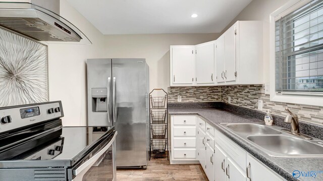 4212 Mcclain Ln NW, Huntsville, AL 35810 - kitchen featuring stainless steel appliances, range hood, a sink, white cabinetry, and recessed lighting
