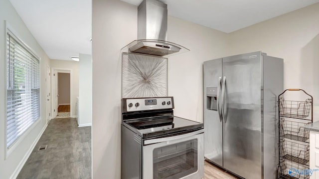 4212 Mcclain Ln NW, Huntsville, AL 35810 - kitchen featuring stainless steel appliances, exhaust hood, light wood-style floors, and baseboards
