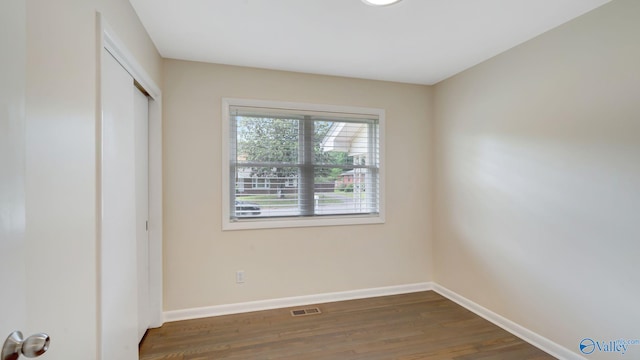 4212 Mcclain Ln NW, Huntsville, AL 35810 - unfurnished bedroom with wood finished floors, baseboards, and a closet