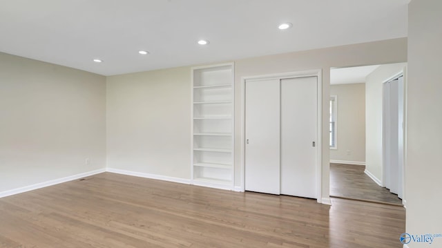 4212 Mcclain Ln NW, Huntsville, AL 35810 - unfurnished bedroom with wood finished floors, baseboards, and recessed lighting