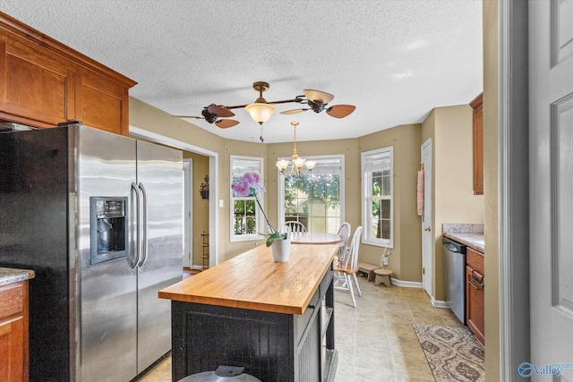 213 Hollington Dr, Huntsville, AL 35811 - kitchen with appliances with stainless steel finishes, a ceiling fan, butcher block countertops, a kitchen island, and a textured ceiling