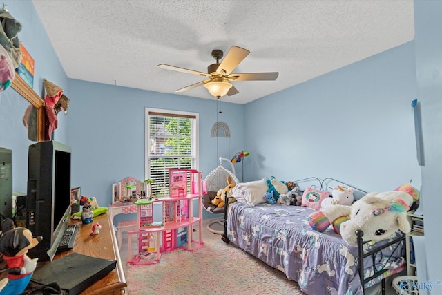 213 Hollington Dr, Huntsville, AL 35811 - carpeted bedroom with a textured ceiling and ceiling fan