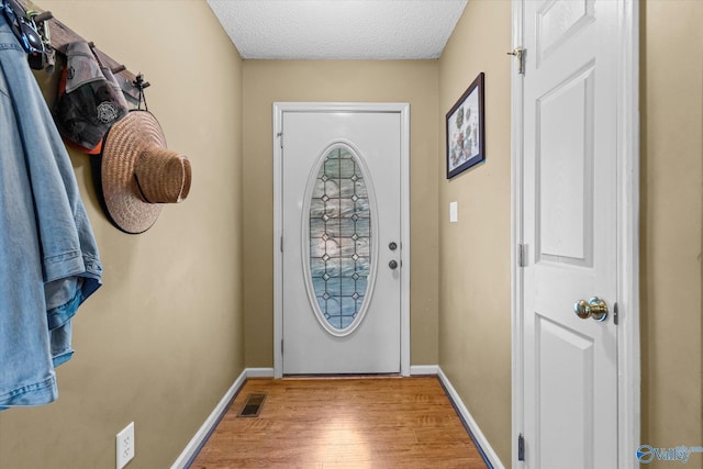 213 Hollington Dr, Huntsville, AL 35811 - doorway to outside with light wood finished floors and a textured ceiling