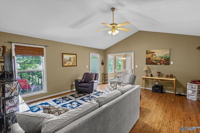 213 Hollington Dr, Huntsville, AL 35811 - living area featuring a ceiling fan, wood finished floors, a chandelier, vaulted ceiling, and a textured ceiling