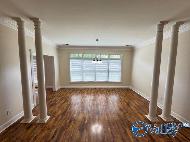 15031 Ashmont Blvd SE, Huntsville, AL 35803 - unfurnished living room with a chandelier, wood finished floors, baseboards, and ornamental molding