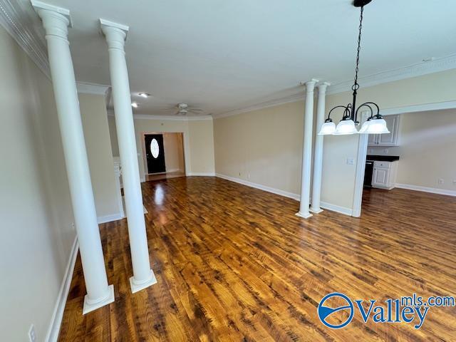 15031 Ashmont Blvd SE, Huntsville, AL 35803 - unfurnished living room featuring dark wood finished floors, baseboards, ornamental molding, and a ceiling fan