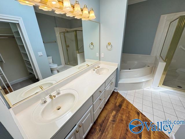 15031 Ashmont Blvd SE, Huntsville, AL 35803 - bathroom featuring a garden tub, a sink, double vanity, and a stall shower
