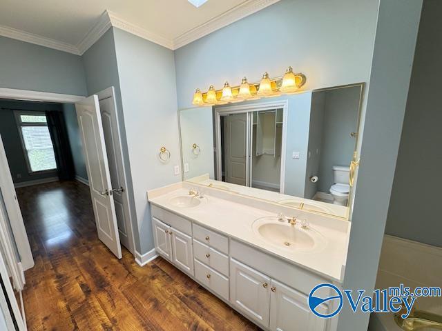 15031 Ashmont Blvd SE, Huntsville, AL 35803 - full bath with wood finished floors, a sink, ornamental molding, and toilet