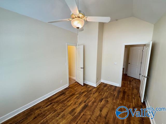 15031 Ashmont Blvd SE, Huntsville, AL 35803 - unfurnished bedroom with lofted ceiling, a ceiling fan, wood finished floors, and baseboards