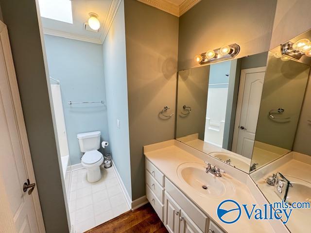 15031 Ashmont Blvd SE, Huntsville, AL 35803 - full bath with baseboards, toilet, vanity, and ornamental molding