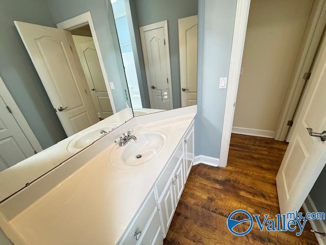 15031 Ashmont Blvd SE, Huntsville, AL 35803 - bathroom with baseboards, wood finished floors, and vanity