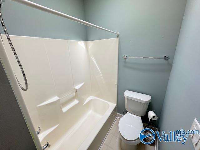 15031 Ashmont Blvd SE, Huntsville, AL 35803 - full bathroom with washtub / shower combination, toilet, and tile patterned floors