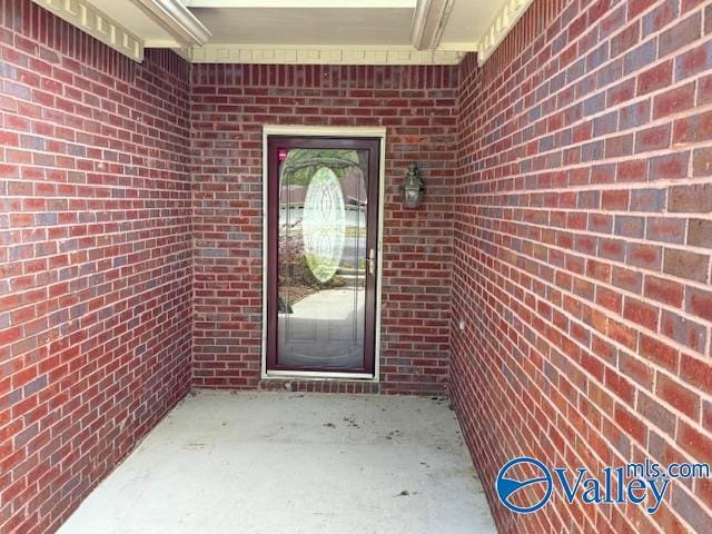 15031 Ashmont Blvd SE, Huntsville, AL 35803 - property entrance featuring brick siding and a patio area