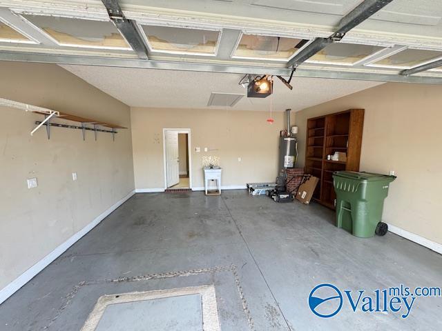 15031 Ashmont Blvd SE, Huntsville, AL 35803 - garage with water heater, baseboards, and a garage door opener